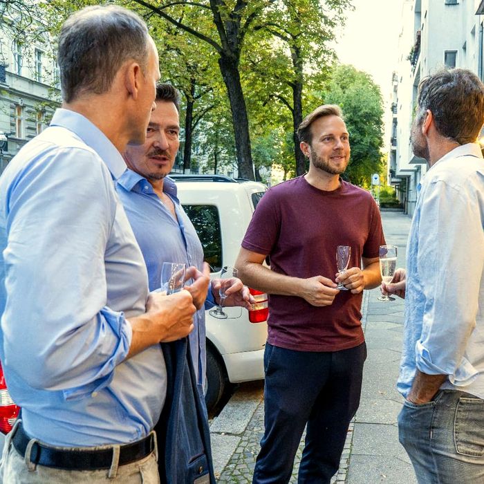Friends with a drink outside Modi Berlin